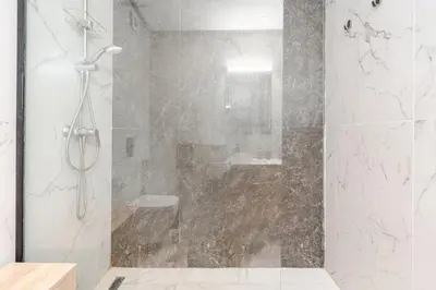 a shower with a glass door in a bathroom at C04 Comfort & Design Studio with Private Terrace CFC in Casablanca