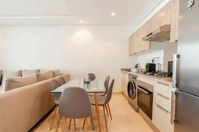 a kitchen and living room with a table and chairs at C04 Comfort & Design Studio with Private Terrace CFC in Casablanca