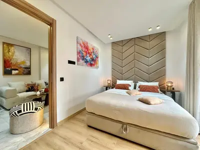 a bedroom with a large bed and a mirror at NESK STAY Maarif - ARENA 41 in Casablanca