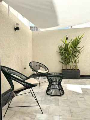 two chairs and a table on a patio at NESK STAY Maarif - ARENA 41 in Casablanca