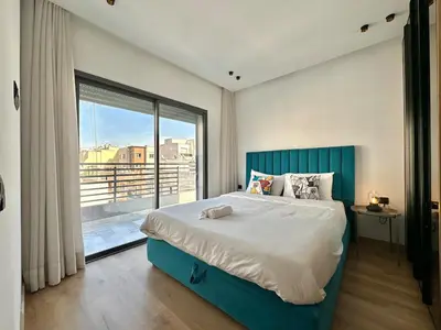 a bedroom with a large bed and a large window at NESK STAY Maarif - ARENA 41 in Casablanca