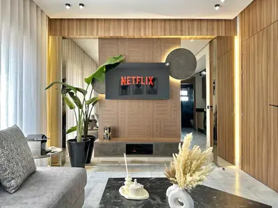 a living room with a television on a wall at NESK STAY Maarif - ARENA 41 in Casablanca