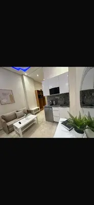 a living room with a couch and a table at Bouznika tour House in Bouznika