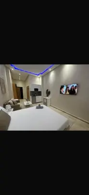 a large living room with a white couch and a tv at Bouznika tour House in Bouznika