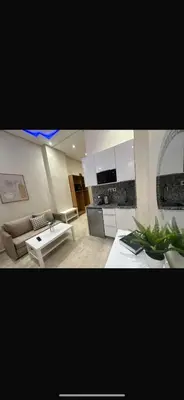 a living room with a couch and a table at Bouznika tour House in Bouznika