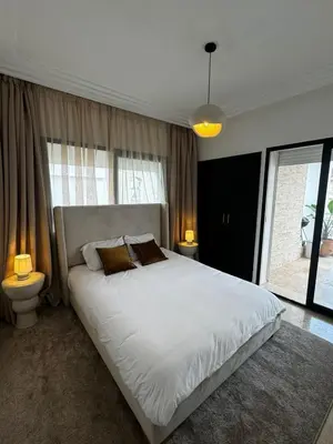 a bedroom with a large white bed with two pillows at Les Perles de Tamaris Beach access Pools in Casablanca