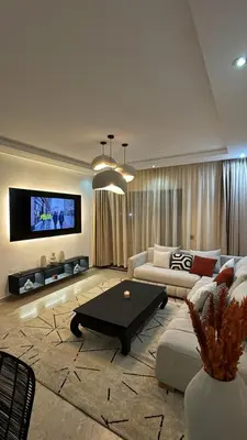a living room with a couch and a table at Les Perles de Tamaris Beach access Pools in Casablanca