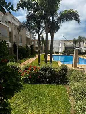 a resort yard with palm trees and a swimming pool at Les Perles de Tamaris Beach access Pools in Casablanca