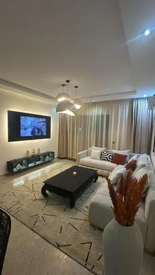 a living room with a couch and a coffee table at Les Perles de Tamaris Beach access Pools in Casablanca