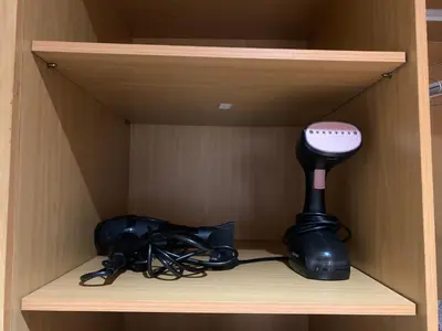 a wooden shelf with a blow dryer and cords at Chic & secure in Casablanca