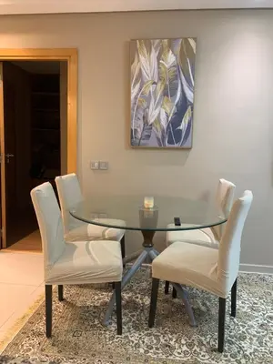 a dining room with a glass table and chairs at Chic & secure in Casablanca