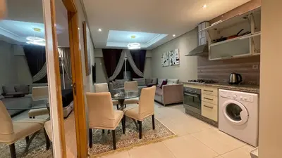 a kitchen and living room with a table and chairs at Chic & secure in Casablanca