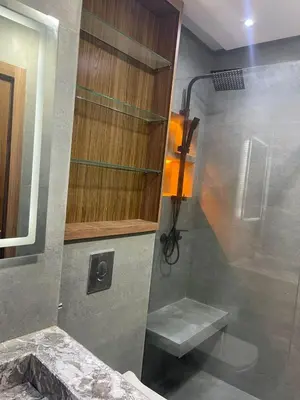 a shower stall with a bench in a bathroom at Appartement Luxueux Mer & Piscine in Mansouria