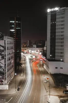 a city street at night with buildings and street lights at Confort Urbain Casablanca Vue Accès Gare Casa Port in Casablanca