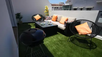 a patio with a couch and a table and chairs at Panoramique Studio a casablanca in Casablanca
