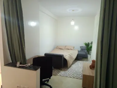 a bedroom with a bed in a room with a window at Appartement neuf, propre et ensoleillé in Temara