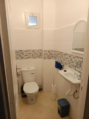 a bathroom with a toilet and a sink at Appartement neuf, propre et ensoleillé in Temara