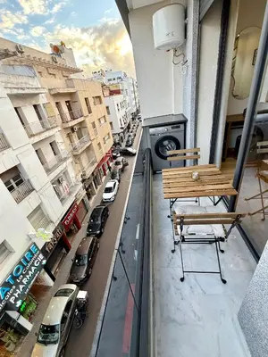 a balcony with a bench and a city street at Arena Maarif in Casablanca