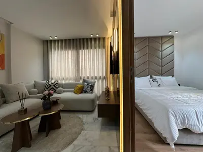 a bedroom with a bed and a couch at Arena Maarif in Casablanca