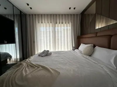 a bedroom with a large white bed with a window at Arena Maarif in Casablanca
