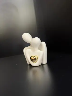 a white figurine of a couple holding a heart at Arena Maarif in Casablanca