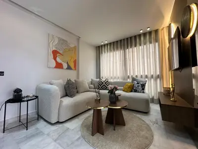 a living room with a couch and a table at Arena Maarif in Casablanca