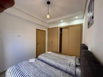 a bedroom with a bed and a couch in it at Vivez Une Expérience Unique à ARMADA in Bouznika