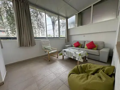 a living room with a couch and a chair at Vivez Une Expérience Unique à ARMADA in Bouznika