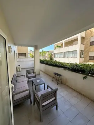 a patio with benches and tables on a building at Vivez Une Expérience Unique à ARMADA in Bouznika