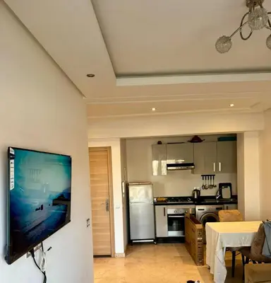 a living room with a flat screen tv on a wall at Studio les princesses in Casablanca