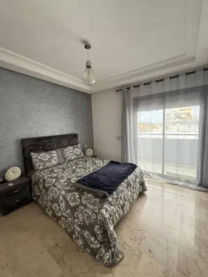 a bedroom with a bed and a large window at Studio les princesses in Casablanca