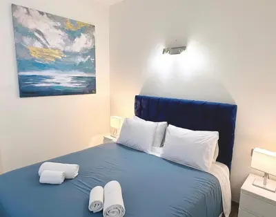a bedroom with a blue bed with two towels on it at private villa with swimming pool in Rabat