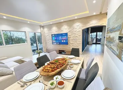 a dining room with a table and a tv at private villa with swimming pool in Rabat