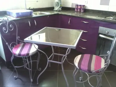 a kitchen with a sink and two bar stools at Rabat Apartments in Rabat
