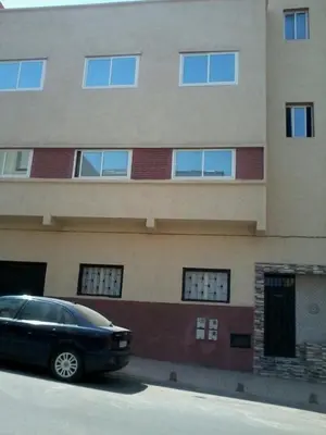a black car parked in front of a building at Rabat Apartments in Rabat