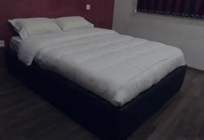 a bed with white sheets and pillows in a bedroom at Rabat Apartments in Rabat