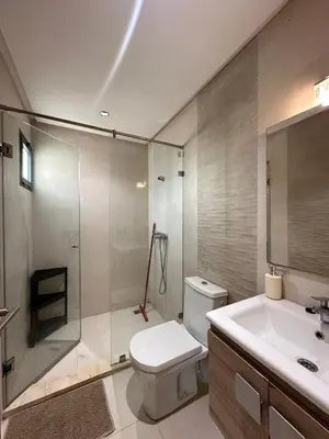 a bathroom with a toilet and a shower and a sink at Logement luxueux avec 2 piscines in Dar Hamida