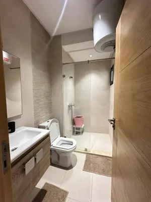 a bathroom with a toilet and a sink and a tub at Logement luxueux avec 2 piscines in Dar Hamida