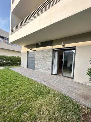 a house with a wooden walkway next to a yard at Logement luxueux avec 2 piscines in Dar Hamida