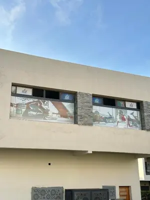 a building with windows with people on it at Logement luxueux avec 2 piscines in Dar Hamida