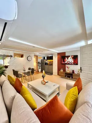 a living room with a couch and a table at Villa 1 Corniche, Seaside Stay at Carrousel Mall, Walk Everywhere in Rabat