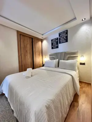 a bedroom with a large white bed with two pillows at Villa 1 Corniche, Seaside Stay at Carrousel Mall, Walk Everywhere in Rabat