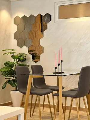 a dining room with a table and chairs with pink candles at Villa 1 Corniche, Seaside Stay at Carrousel Mall, Walk Everywhere in Rabat