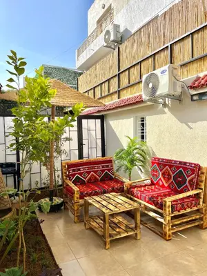 a patio with two couches and a table at C2, Modern Charm apartment Facing Carrousel with Ocean View in Rabat