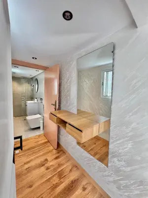 a bathroom with a sink and a toilet in a room at C2, Modern Charm apartment Facing Carrousel with Ocean View in Rabat
