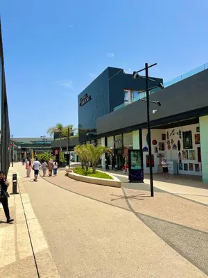 a city street with people walking down a street at C2, Modern Charm apartment Facing Carrousel with Ocean View in Rabat