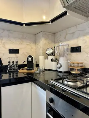 a kitchen with a stove and a counter top at Appartement chic - Princesses in Casablanca