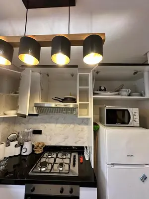 a kitchen with a stove top and a refrigerator at Appartement chic - Princesses in Casablanca