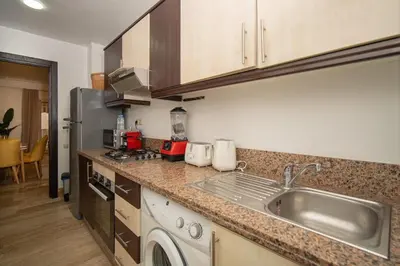 a kitchen with a sink and a dishwasher at Studio chic- les princesses Maarif in Casablanca