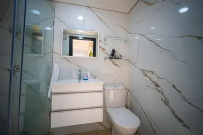 a bathroom with a toilet and a sink and a mirror at Studio chic- les princesses Maarif in Casablanca